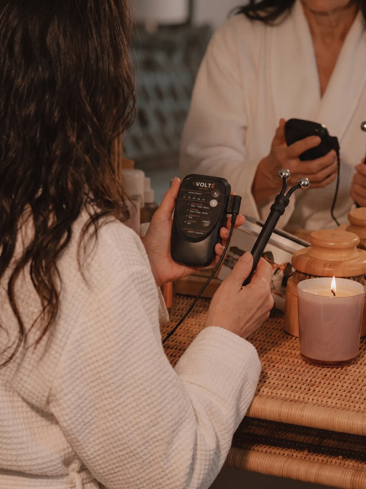 Woman using the VOLTÉ Lift Pro while sitting comfortably at home